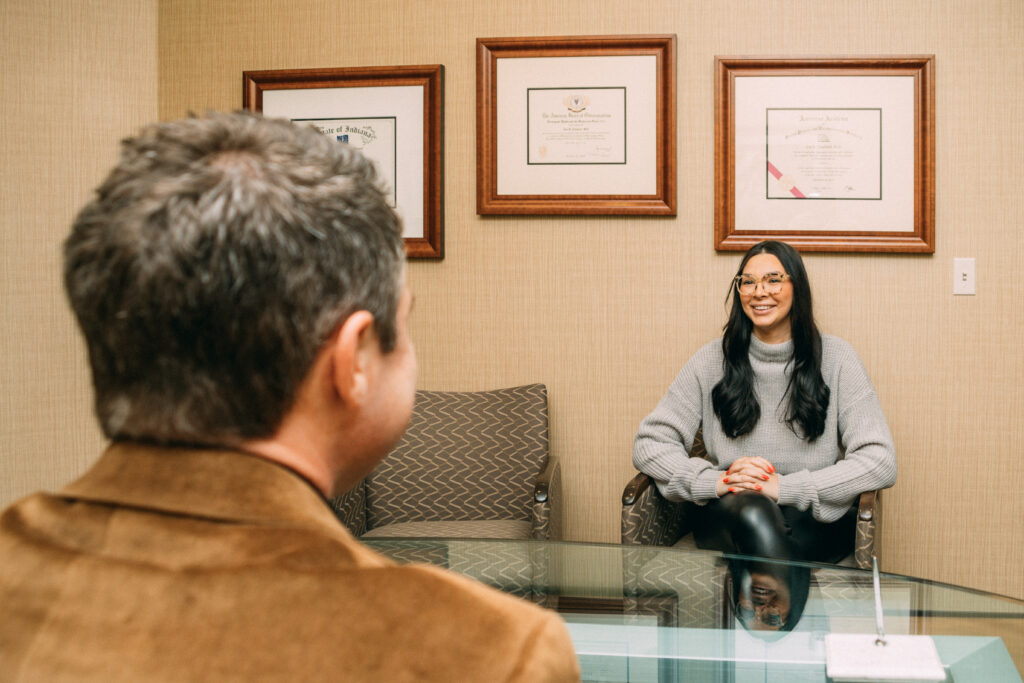 Dr. Chadwell speaking with a woman client sitting down