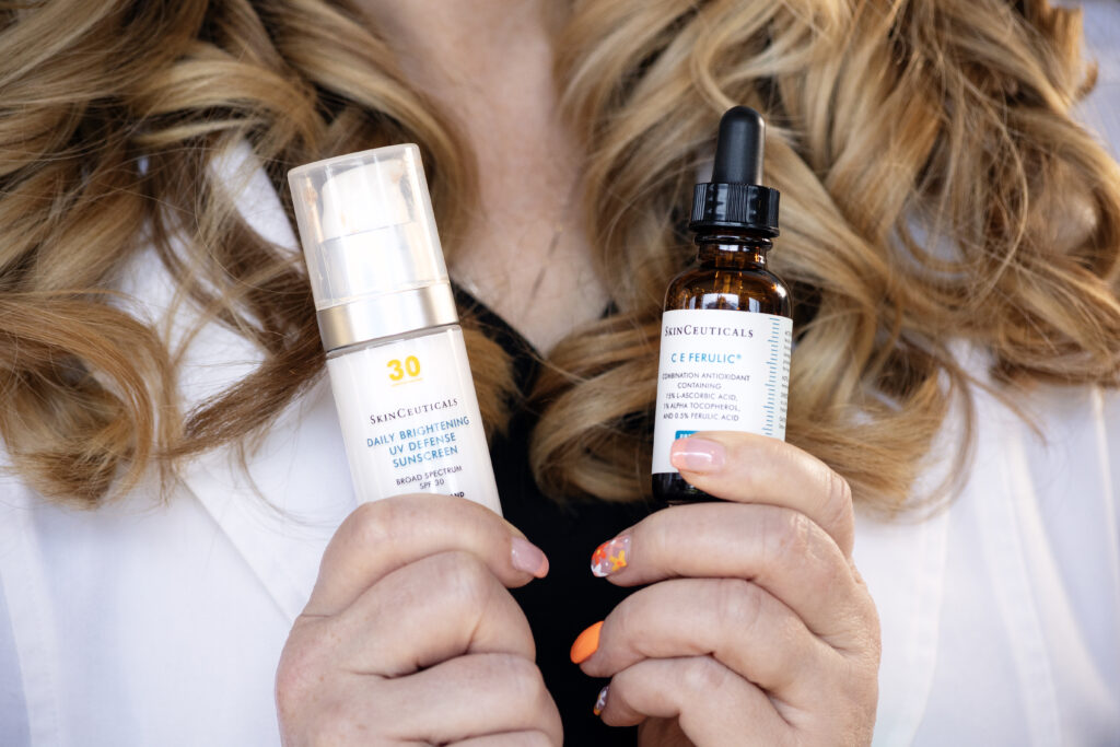 Esthetician holding Skinceuticals products